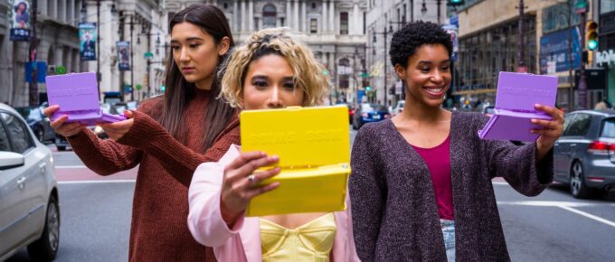 woman in red long sleeve shirt holding yellow paper